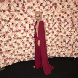 Sleeveless red cape gown